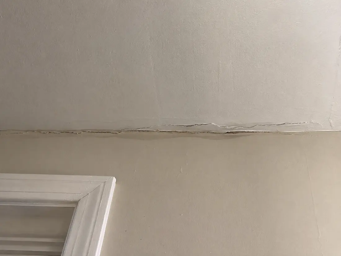 Crack running along a drywall joint where tape has released