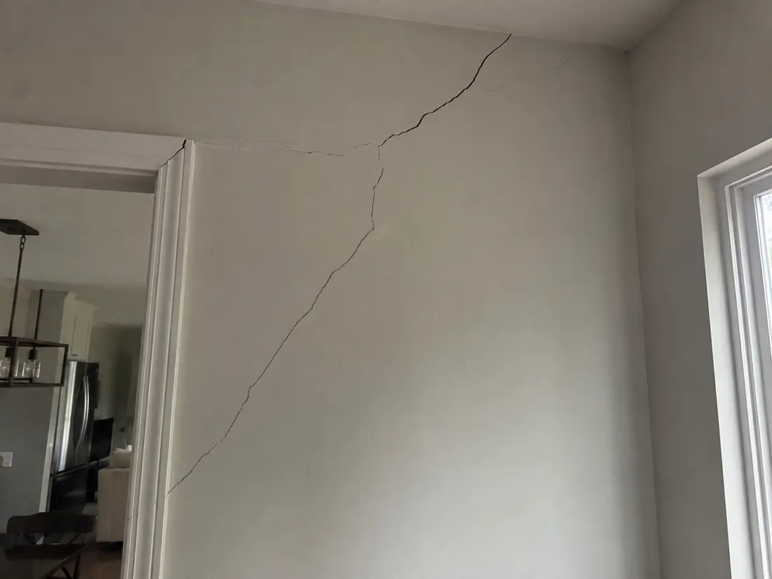 Diagonal settlement crack above a door frame in a Shreveport home